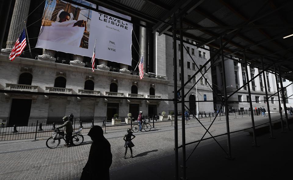 People walk past the New York Stock Exchange (NYSE) at Wall Street on February 17, 2021 in New York City. (Photo by Angela Weiss / AFP) (Photo by ANGELA WEISS/AFP via Getty Images)